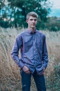 Young man standing on field 