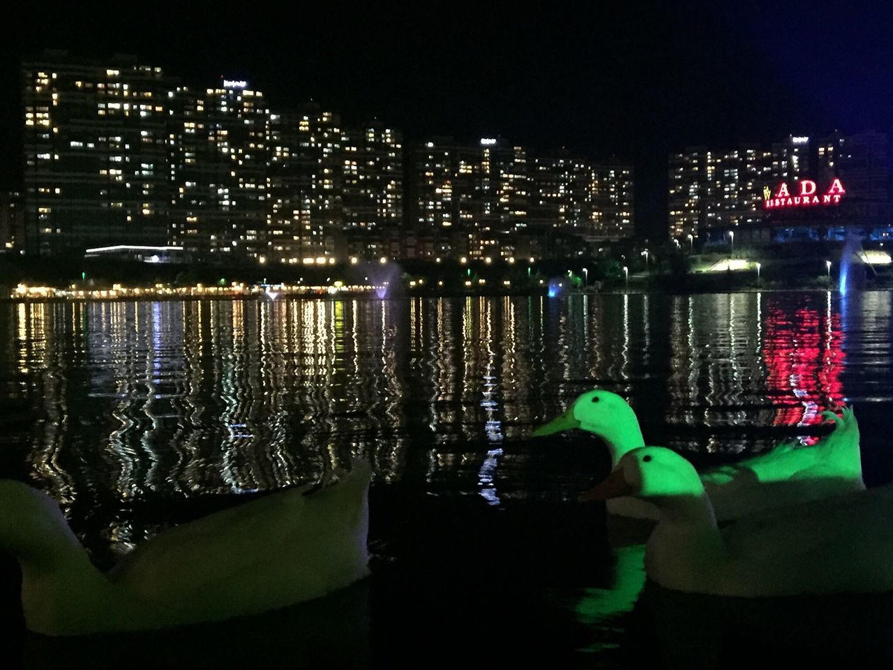 city, reflection, water, night, architecture, building exterior, cityscape, illuminated, skyscraper, built structure, nautical vessel, outdoors, urban skyline, no people, sky