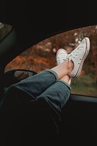 Low section of man standing in car