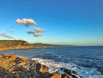 Scenic view of sea against blue sky