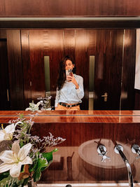 Portrait of woman sitting on table