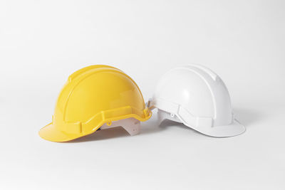 Close-up of yellow hat against white background
