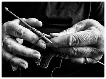 Cropped image of person knitting wool