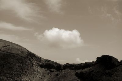 Scenic view of mountains against cloudy sky