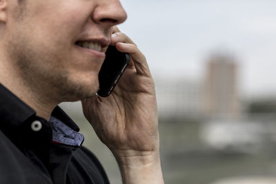 Midsection of man talking on mobile phone