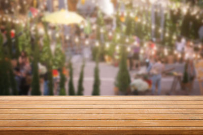 Close-up of people on bench against blurred background