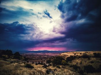 Scenic view of dramatic sky over land