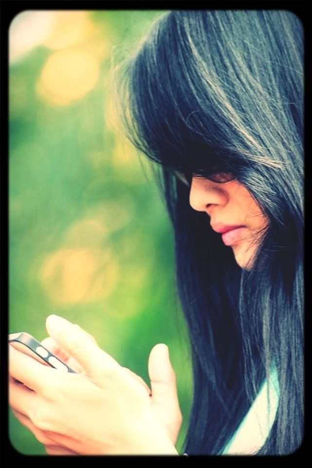 transfer print, young adult, young women, lifestyles, auto post production filter, person, long hair, leisure activity, headshot, head and shoulders, holding, close-up, waist up, black hair, front view, focus on foreground