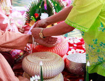 Midsection of women holding flowers