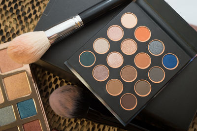 High angle view of eyeshadow palettes on table