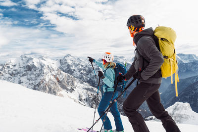 Rear view of man skiing on snowcapped mountain