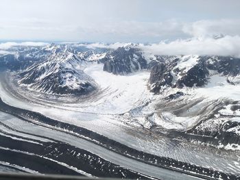 Aerial view of snowcapped mountains against sky