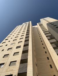 Low angle view of modern building against clear blue sky