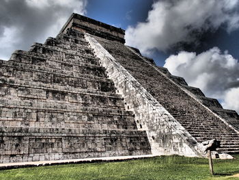 Low angle view of old building against cloudy sky