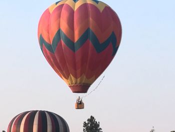 Hot air balloons flying against clear sky