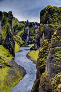 Scenic view of waterfall against sky