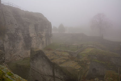 Scenic view of landscape against sky during foggy weather