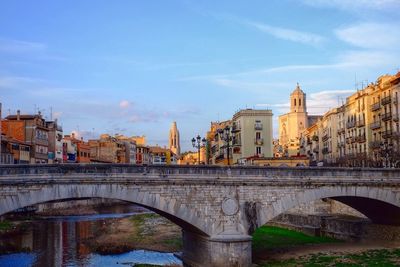 Bridge over river with buildings in background