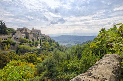 Panoramic view of trees and buildings against sky