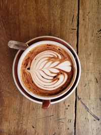 Directly above shot of cappuccino with coffee cup