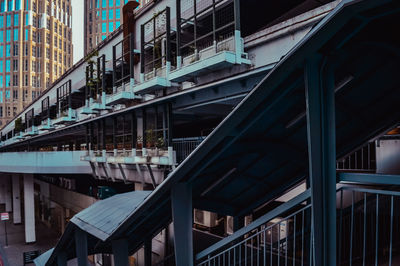 Low angle view of bridge amidst buildings in city