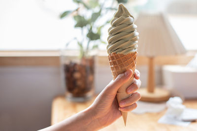 Cropped hand of person holding ice cream cone