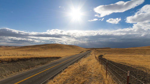 Empty road with sky in background