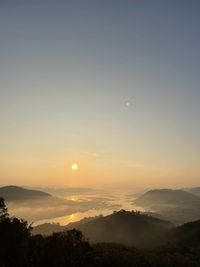 Scenic view of silhouette mountains against sky during sunset