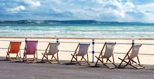 Deck chairs in front of beach