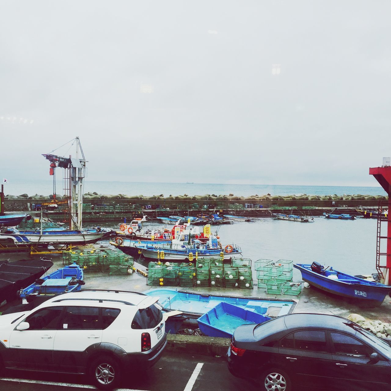 transportation, mode of transport, nautical vessel, car, water, sea, land vehicle, sky, boat, moored, road, travel, high angle view, copy space, harbor, cloud - sky, outdoors, built structure, day, no people