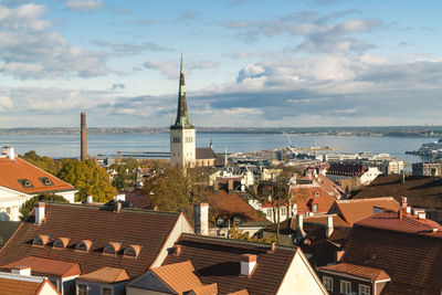 View of the old town with st olaf's church tower and the baltic sea