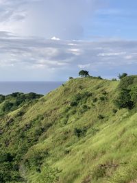 Scenic view of land and sea against sky