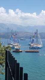 Sailboats in sea against sky