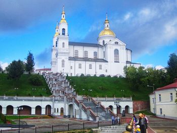 People in front of building against sky