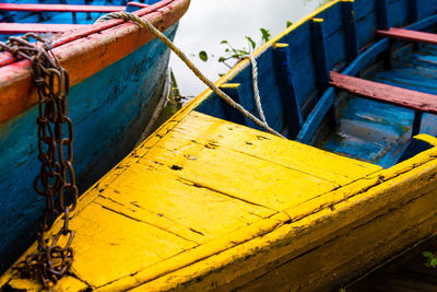 Close-up of fishing boat moored at pier