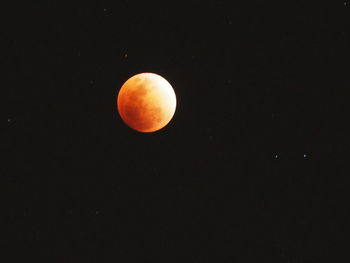 Low angle view of moon against clear sky at night