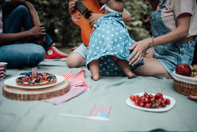 Rear view of people sitting on table