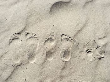 High angle view of footprints on sand at beach