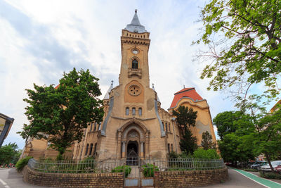 Low angle view of clock tower against sky