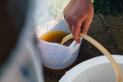 Midsection of person preparing food in bowl