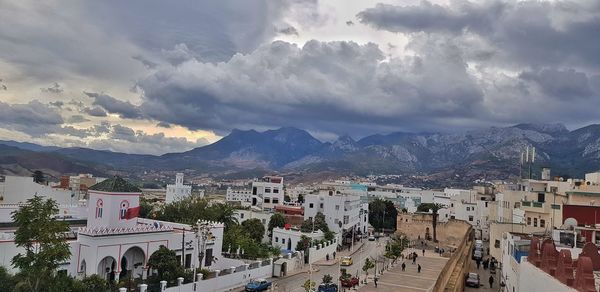 High angle view of townscape and mountains against sky