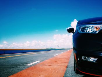 Close-up of road against blue sky