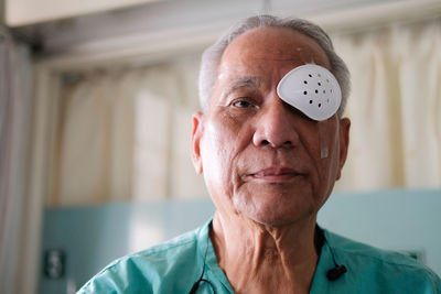 Close-up portrait of senior man at home