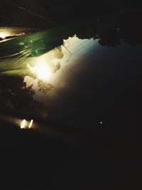 Reflection of illuminated lights in puddle