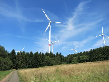 Windmill on field against sky