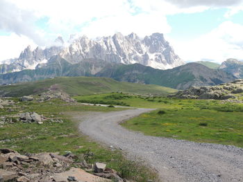 Scenic view of mountains against cloudy sky