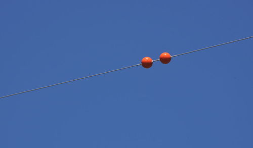 Low angle view of cables against clear blue sky