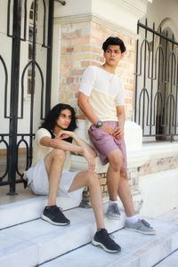 Portrait of smiling young couple sitting outdoors