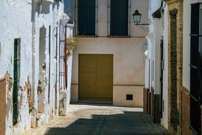 Empty alley amidst buildings in city