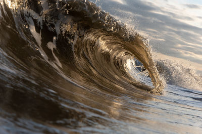 Low angle view of wave splashing on beach